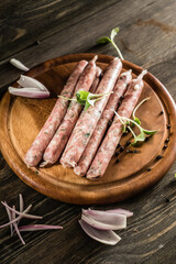 raw sausages with onion and herbs