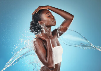 Water, cleaning and black woman with a splash on body, wellness and care with hydration against a...