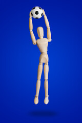 Football wooden toy figure on blue