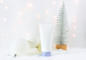 A mock-up of a bottle with a cosmetic product for skin care on a Christmas background. New Year's advertising of cosmetics. Winter cosmetics sale.