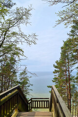 Wooden staircase for descending to the sea or ocean. Beach line. beautiful scenic view, relaxing...
