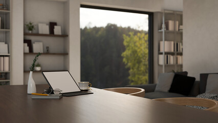 Modern dark wood dining table with tablet mockup over blurred modern cozy home living room