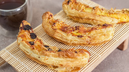 Banana Milk Pastry, made from banana, milk, eggs, flour with grated cheese and chocolate in selective focus.