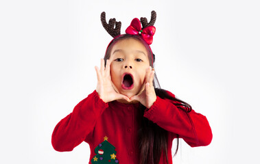 Little asian kid in red sweatshirt Christmas theme costume posing shouting on white background.