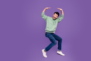 Full length photo of nice young man hold falling heavy empty space wear trendy gray isolated on...