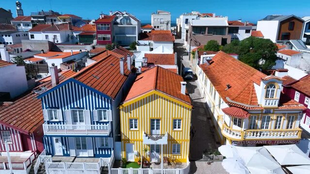 Colored houses on the beach of Costa Nova on the shore of the Ria de Aveiro on the Atlantic coast of Portugal. It belongs to the city of Ilhavo. Aerial view from a drone. Portugal. Europe