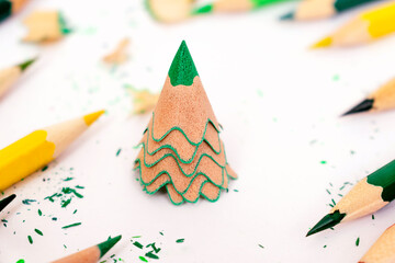 Colored pencils and creative Christmas tree made of shavings from a green pencil.Christmas and New...
