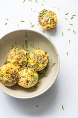 Bowl with egg muffins and chives sprinkled around