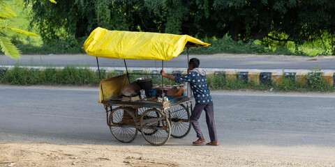 Vendedor ambulante indio empujando su carro