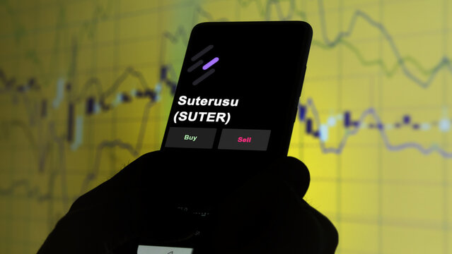 November 3th 2022, Berlin. An investor's analyzing the Suterusu token 'SUTER' coin on screen. A phone shows the suterusu crypto 's prices to invest