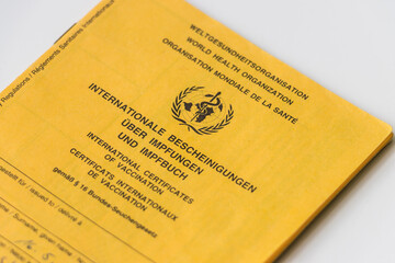 Cover sheet from the World Health Organization vaccination card. Yellow card with proof of...
