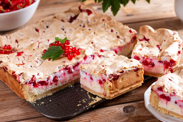 Appetizing homemade berry pie. Pie with red currants and sour cream on wooden table