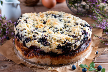 Fresh-baked blueberry cake on wooden table. Baked goods concept.