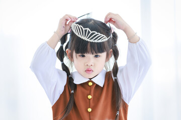 Closeup shot of Millennial Asian happy cheerful little cute preschooler daughter girl role playing...