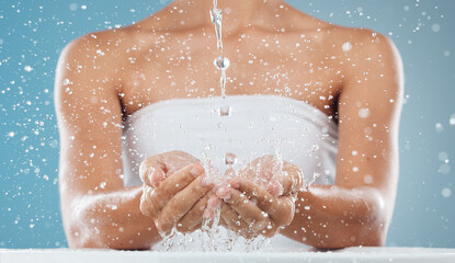 Water, splash and woman hands in a studio for hygiene, grooming or natural facial wash treatment....