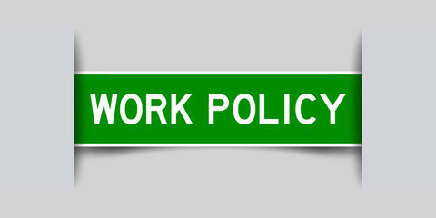 Inserted green color label sticker with word wokr policy on gray background