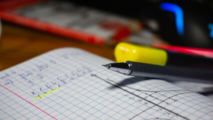 Close up view of pencil - take notes to paper notebook working studying. Student write records to daily planner by hand at home work desk.