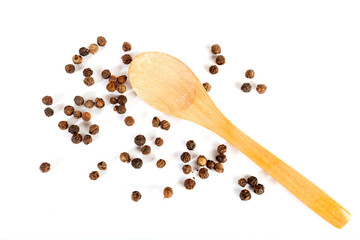 Pepper grains and wooden spoon isolated on white background