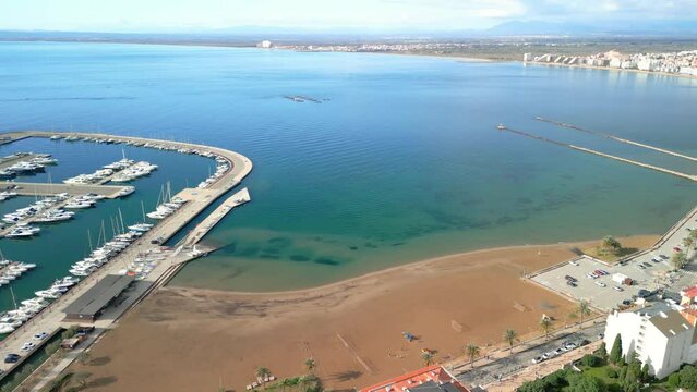 Aerial images of the city of Roses on the Costa Brava in Girona Mediterranean beach region of Alto Ampurdán Spectacular aerial image of the marina with calm water Empuriabrava in the background