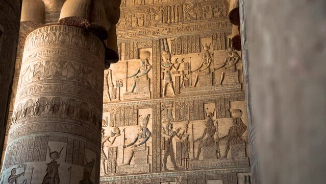 inside pyramids temple in Egypt close up detailed carved stone wall with ancient hieroglyph alphabet 