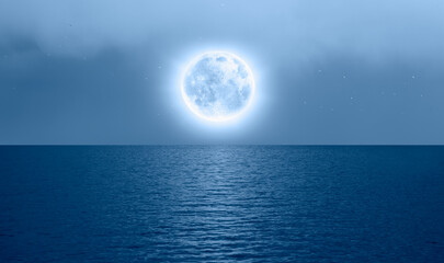 Naklejka na ściany i meble Night sky with blue moon in the clouds over the calm blue sea 