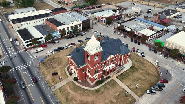 The town of Jackson in the State of GA used for stranger things as "Downtown Hawkins" Part 2 - Buildings and transit driving by and parked During morning time.
