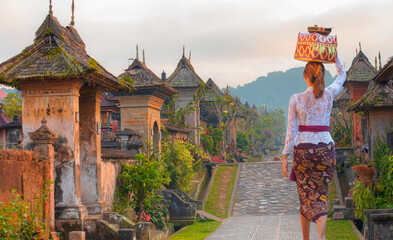 Balinese women carrying on religious offering - Penglipuran is a traditional oldest Bali village at...