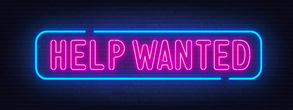 Help Wanted neon sign on brick wall background.