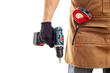 Man in apron and gloves holds cordless screwdriver on white background