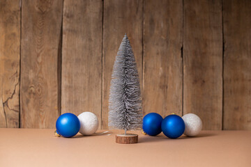 Decorative Christmas tree and Christmas tree decorations on wooden background.