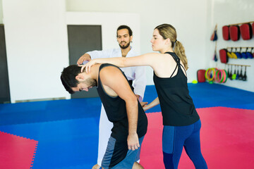Young man and woman at a self-defense class