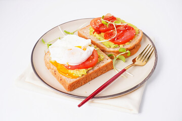 Breakfast, avocado on wholemeal bread and boiled egg on white background