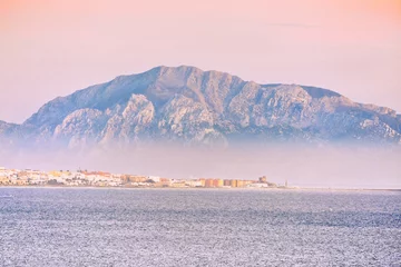 Acrylic prints Bolonia beach, Tarifa, Spain musa mountain in tarifa sea with fog and sunrise colors calm sea beautiful landscape