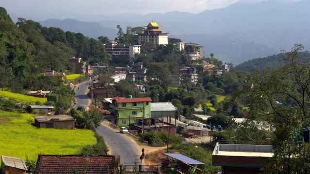 A view of the Neydo Tashi Choling Monastery in the small town of Dakshinkali in Nepal surrounded with mustard fields.