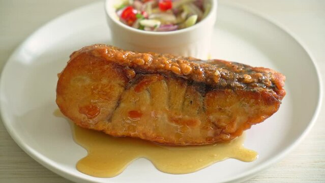 fried snapper fish with fish sauce and spicy salad - Asian food style