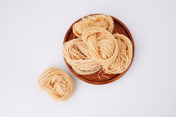 Yellow noodles flour raw materials for cooking on a white background