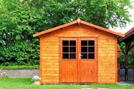 Frontal view of wooden garden shed in a summer