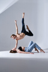 Emotional beautiful couple of modern ballet dancers jumping in jeans. Concept of art, sport,...