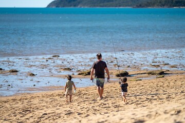 white sand beach in queensland Australia with boats and tourism