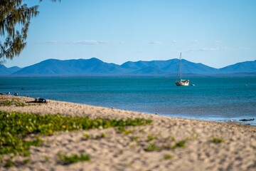 white sand beach in queensland Australia with boats and tourism