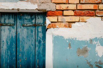 Close up of window and ruined wall of ancient house in Burano