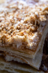 Cake Napoleon, piece of crispy pie close-up. Layered baking.