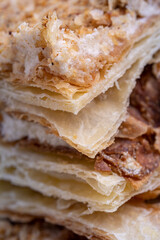 Cake Napoleon, piece of crispy pie close-up. Layered baking.