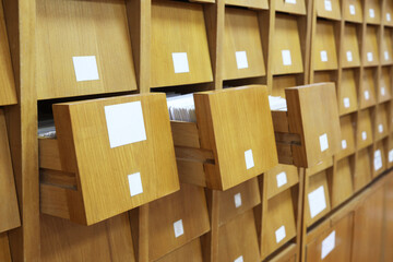 Wooden drawers for archives documents files and folders. Aged way of keeping data concept - obrazy, fototapety, plakaty