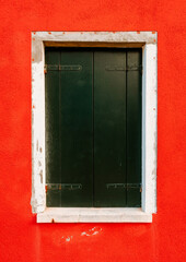 Obraz na płótnie Canvas Close up of window on red housing wall