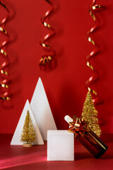 Cosmetic Dropper Bottle on Lying on Podium Christmas Gold Tree and Ribbon Red Background Oil or Serum or Fruit Peeling Xmas Beauty Composition