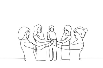 group of women stands with their hands together - one line drawing vector. concept women's union, feminism, women's solidarity,  team, friendship, women's club
