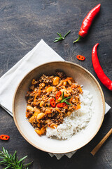 Chili Con Carne in bowl on dark background. Mexican cuisine. chili con carne - minced meat and vegetables stew in tomato sauce. Top view