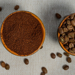 coffee beans, ground coffee in cups on a linen background