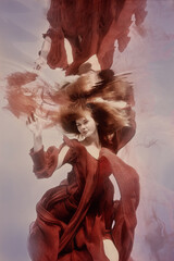 Girl in a red dress underwater emotional portrait
